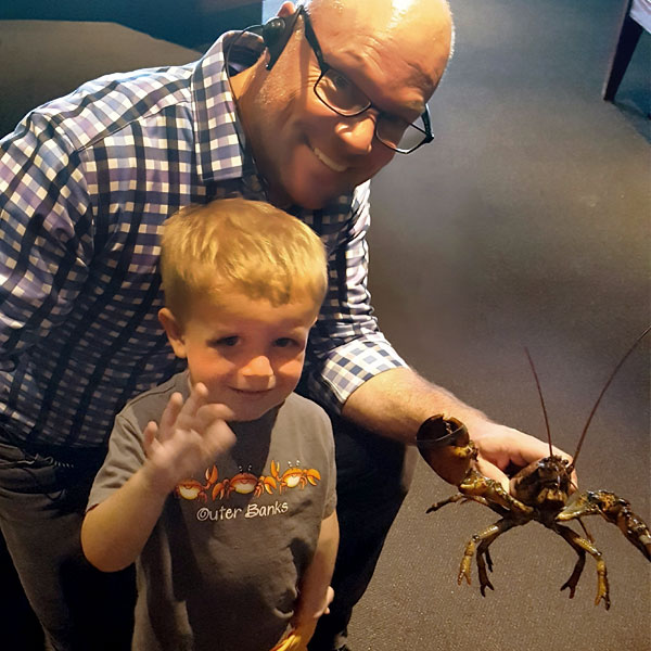 Our manager, a young boy, and his first lobster