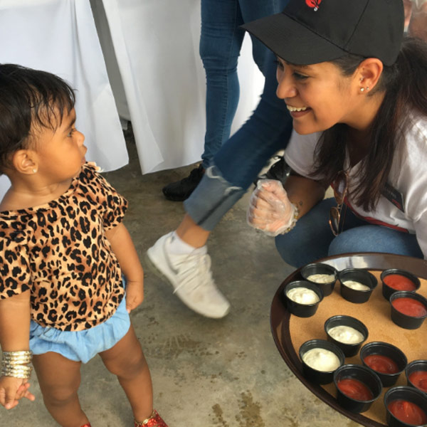 One of our servers volunteering in Puerto Rico interacts with a young child