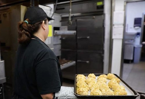A Red Lobster baker prepaires their famous Cheddar Bay Biscuits.