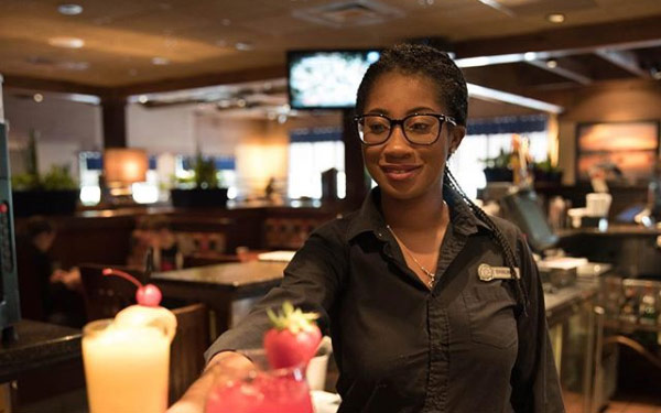Shauna, a bartender at Red Lobster, servers cocktails to patrons.