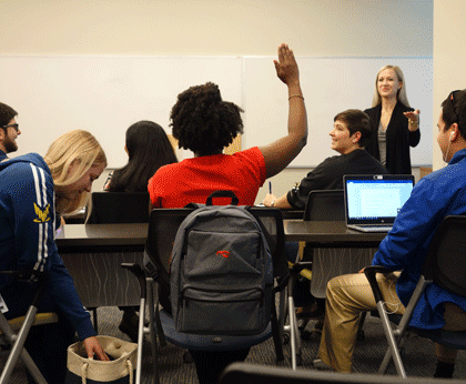 Student raising hand to participate in class